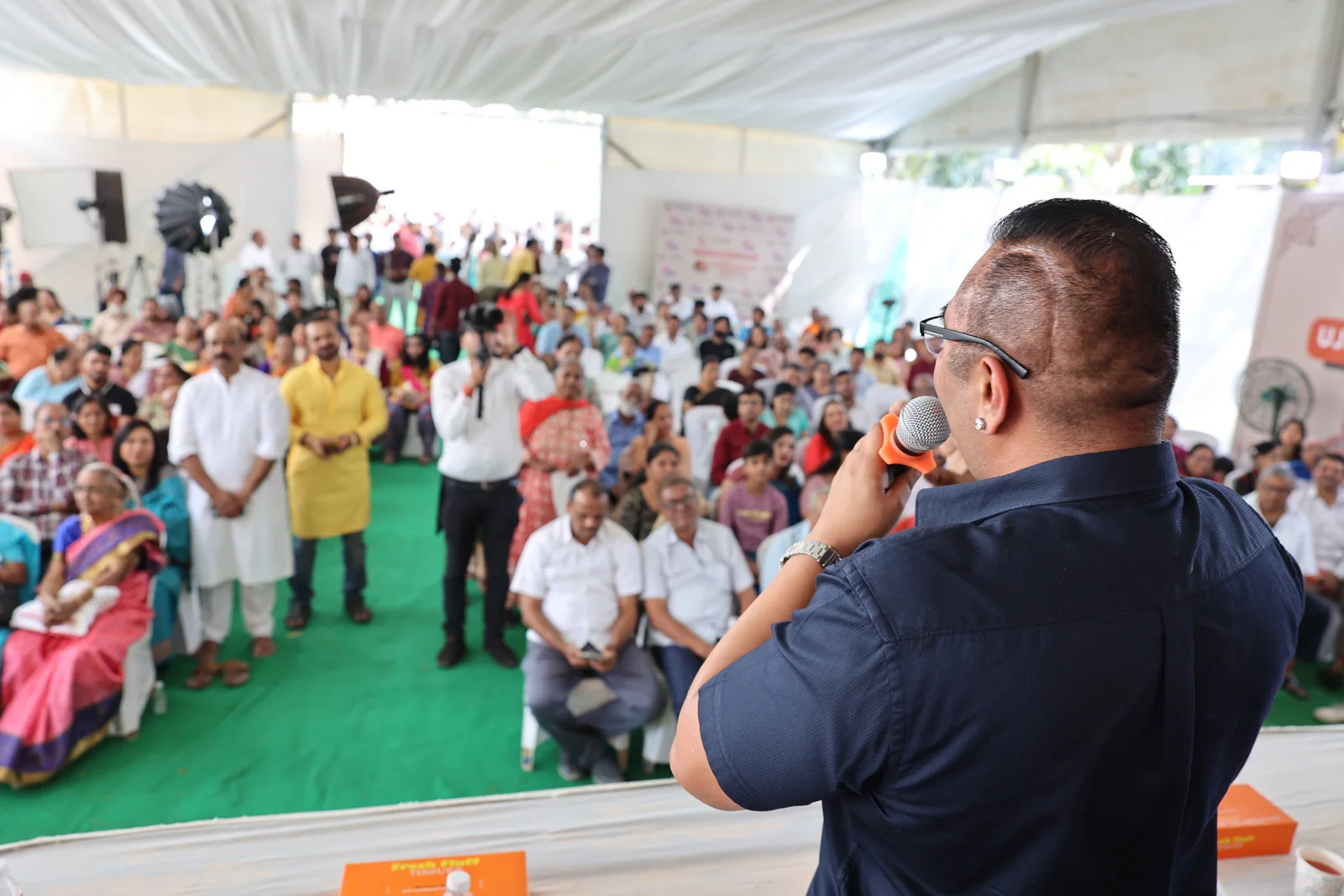 Dr. Anand Modi communicating with a public group during a live engagement.
